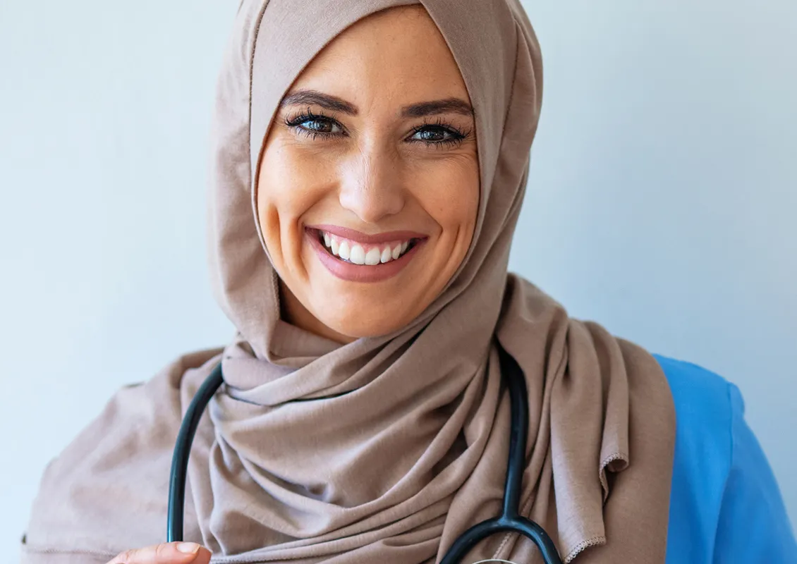 Une femme porte un stéthoscope autour de son cou.